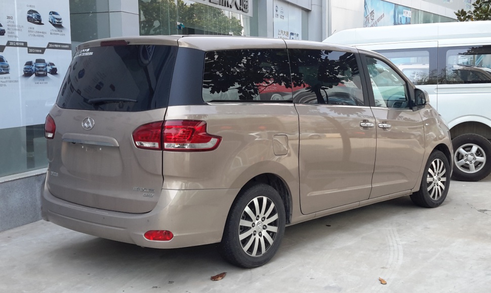 Rear and side view of a minivan with taillights and dark tinted windows
