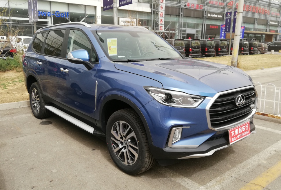 Blue metallic SUV front side with LED headlights and alloy wheels