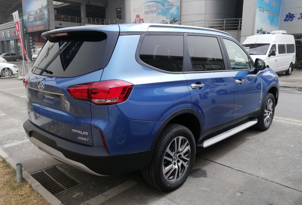 Rear side of blue SUV with alloy wheels and tinted windows