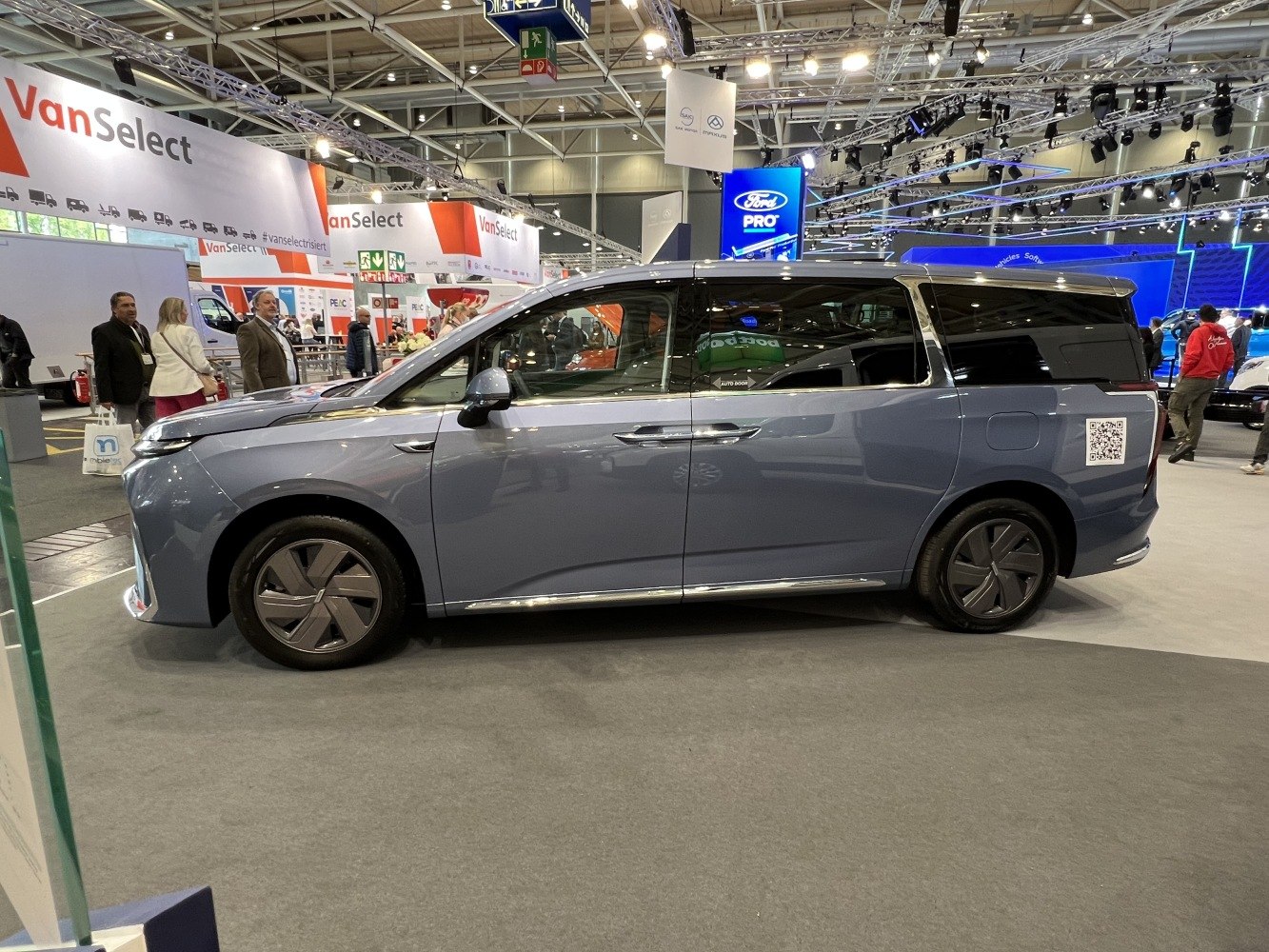 Side profile of modern minivan with sliding doors and aerodynamic body.