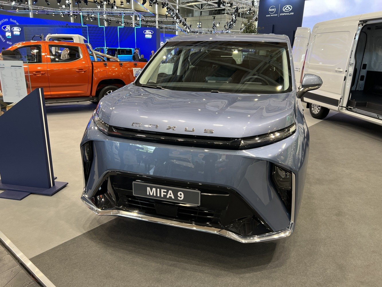 Futuristic front view with LED light bar and angular grille.