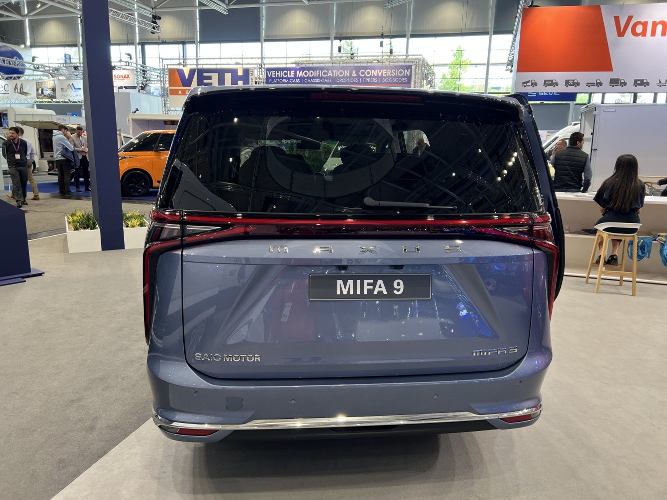 Rear view of modern electric MPV with wide tail light and large rear hatch