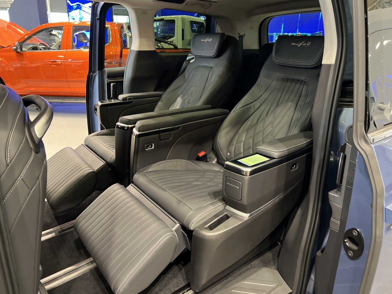 Luxury reclining captain seats with leg rests and armrests.