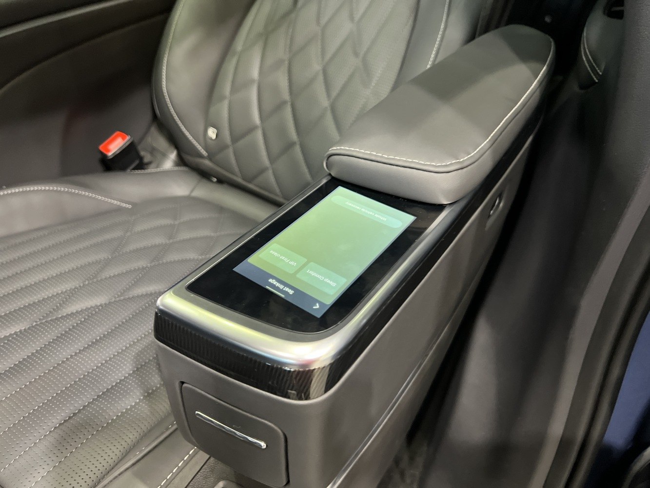 Touchscreen integrated center armrest and quilted leather seat