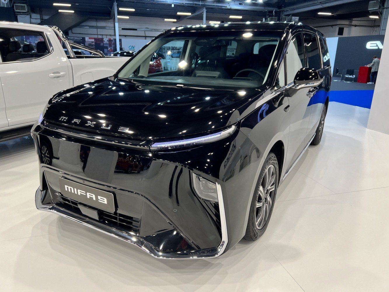 Front angled view showcasing sleek LED headlights and aerodynamic modern minivan design.