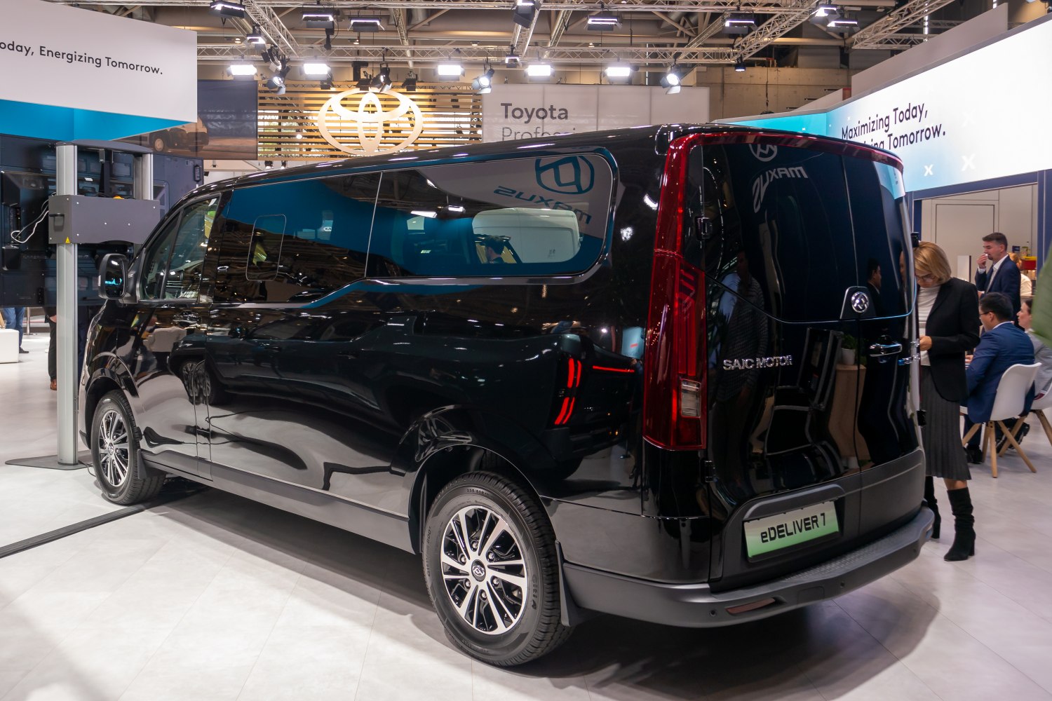 Rear and side view of an electric van with sleek black finish and distinctive taillights