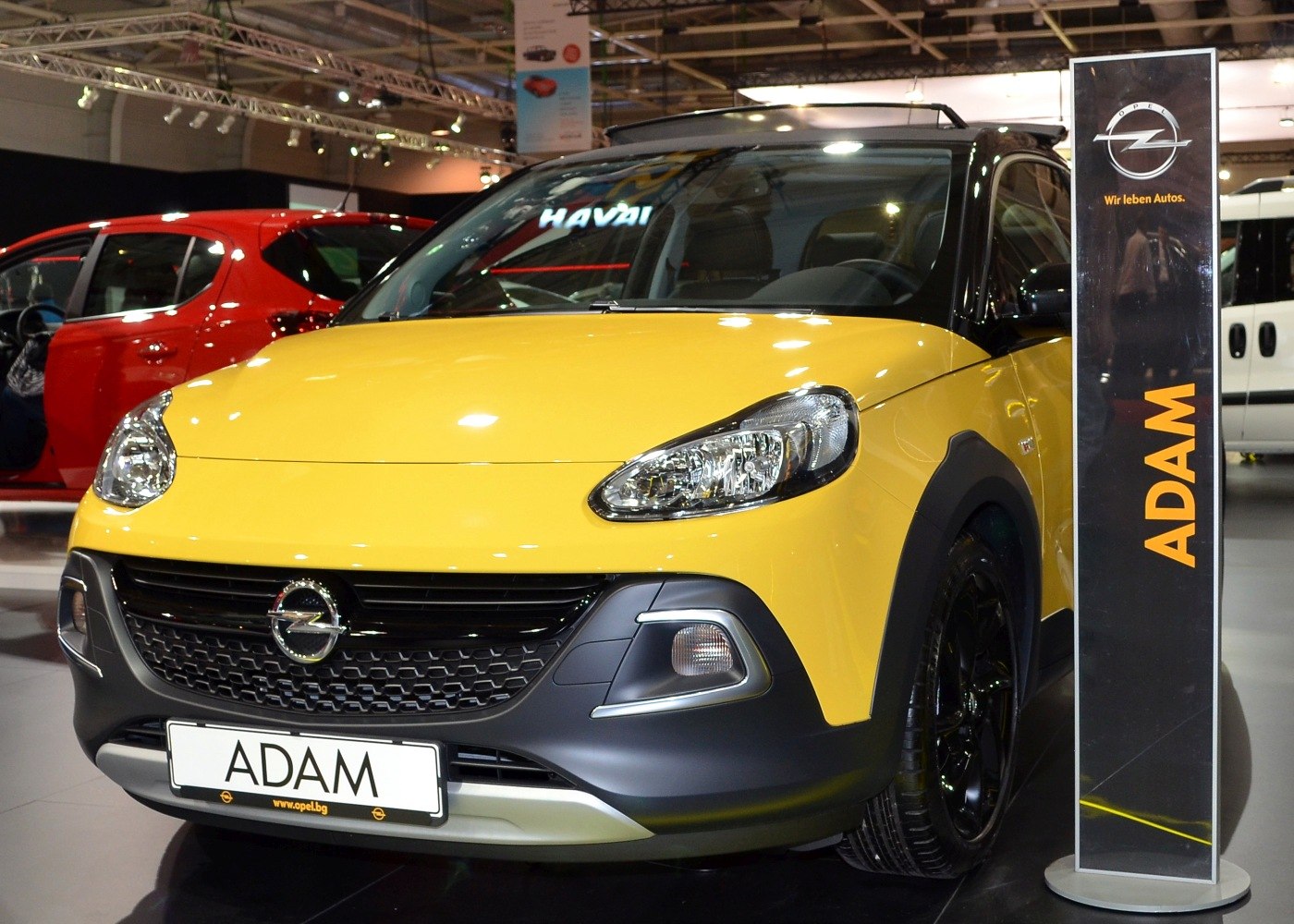 Compact yellow hatchback front with black grille and sporty accents