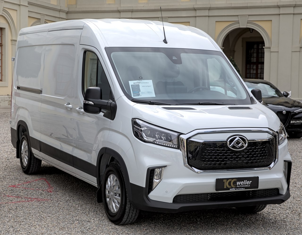 Front view of a white electric cargo van with modern grille and headlights