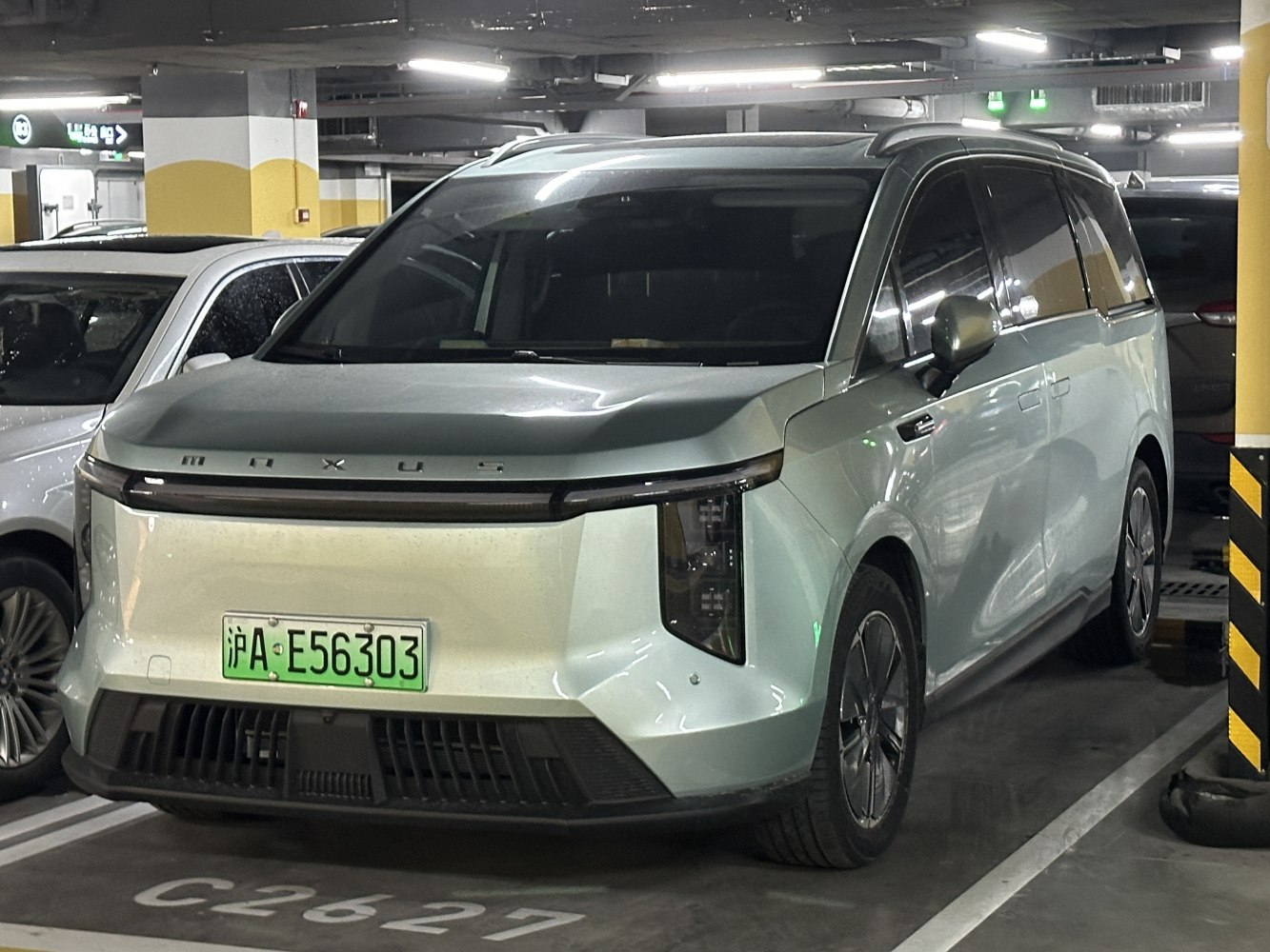 Front view of electric MPV with sleek headlights and modern grille
