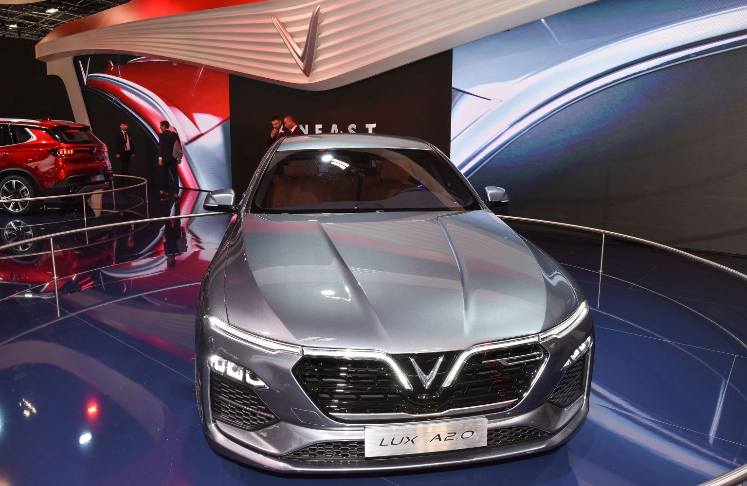 Front view of a luxury sedan with aggressive grille and LED headlights
