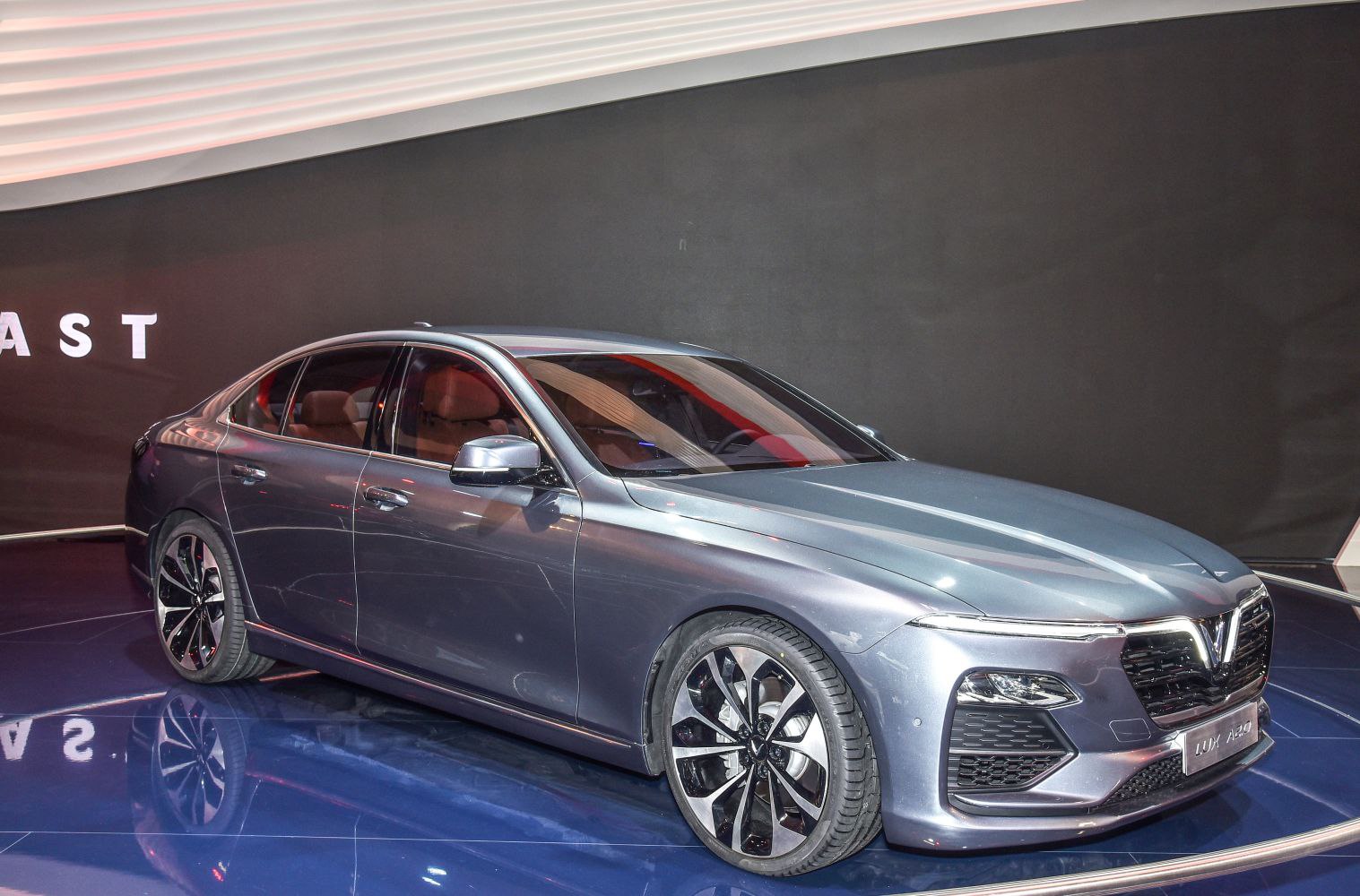 Sleek sedan front side view with modern headlights and alloy wheels