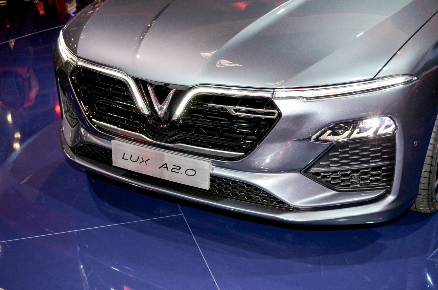 Front grille and LED headlights with VinFast emblem on gray vehicle