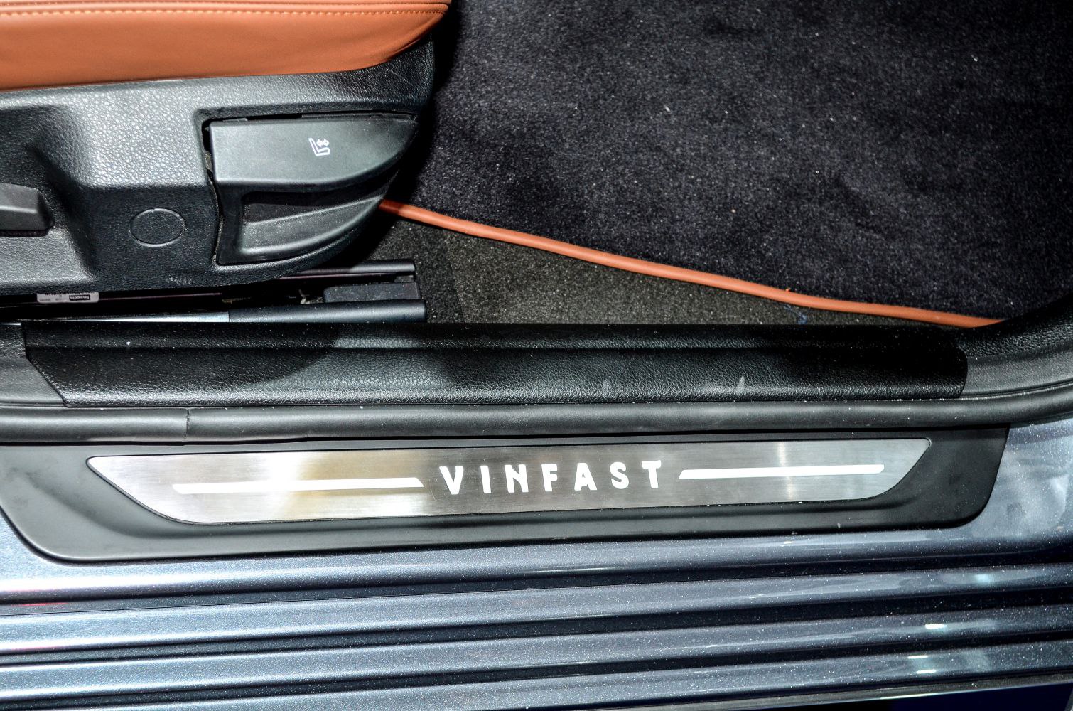 VinFast door sill plate with seat adjustment lever in car interior