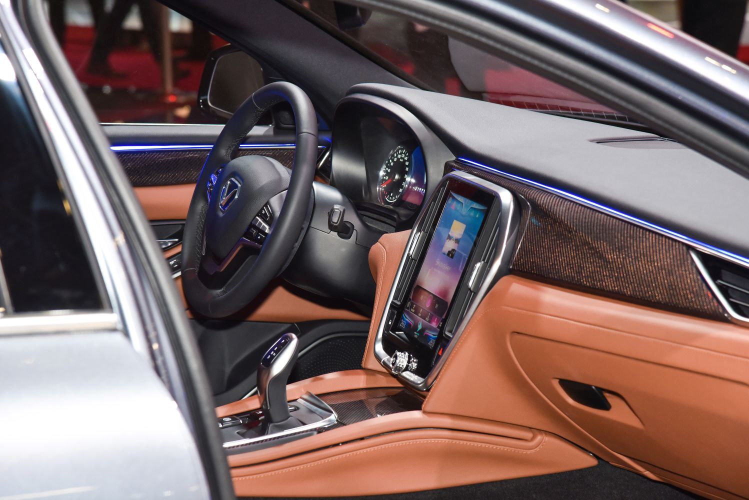 Luxury car interior with vertical touchscreen and brown leather upholstery