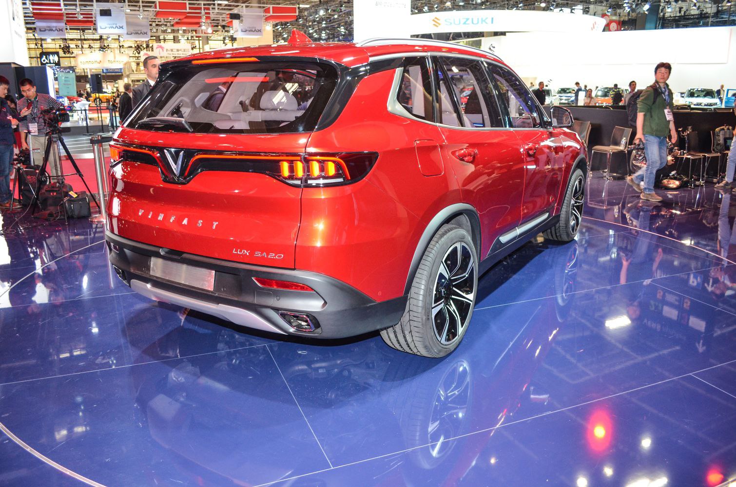 Rear view of red SUV with distinctive LED taillights and alloy wheels.