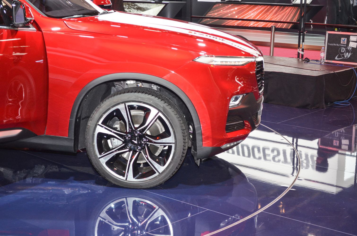 Close-up of front wheel rim and sleek headlight design