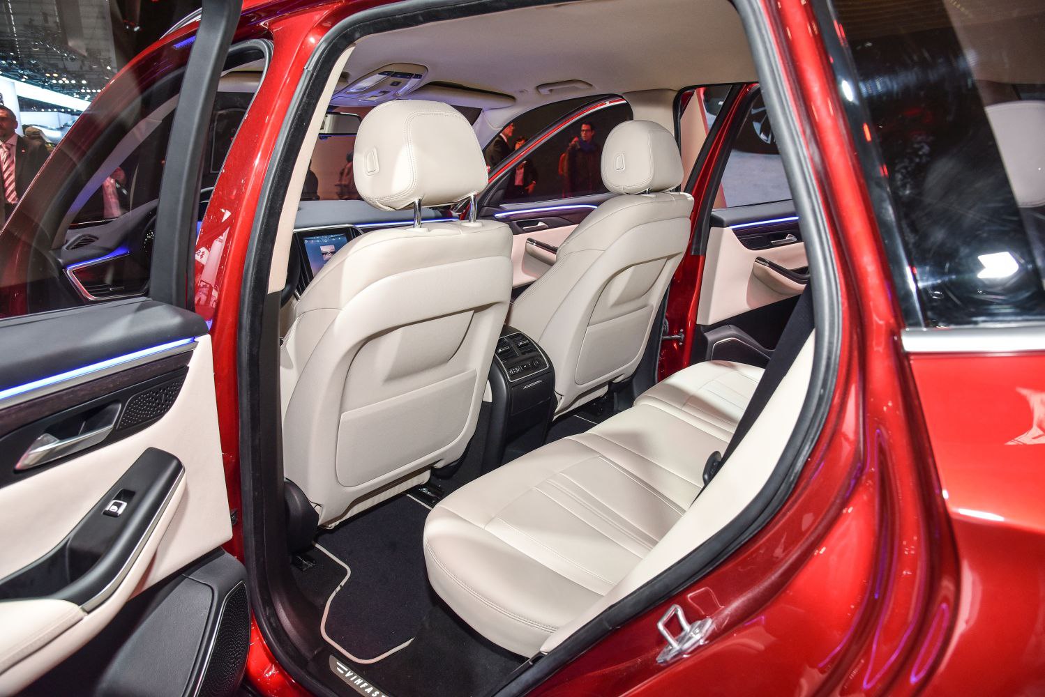 Spacious rear seating with beige leather upholstery and modern door panel