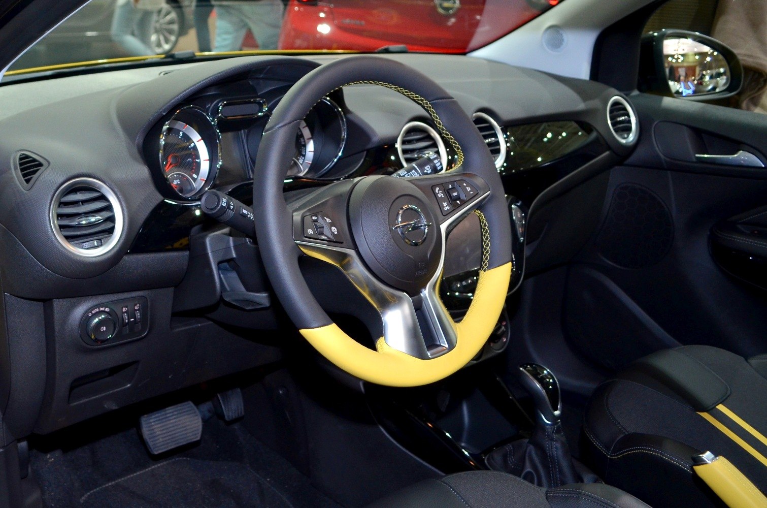 Yellow-black steering wheel and modern dashboard interior with pedals