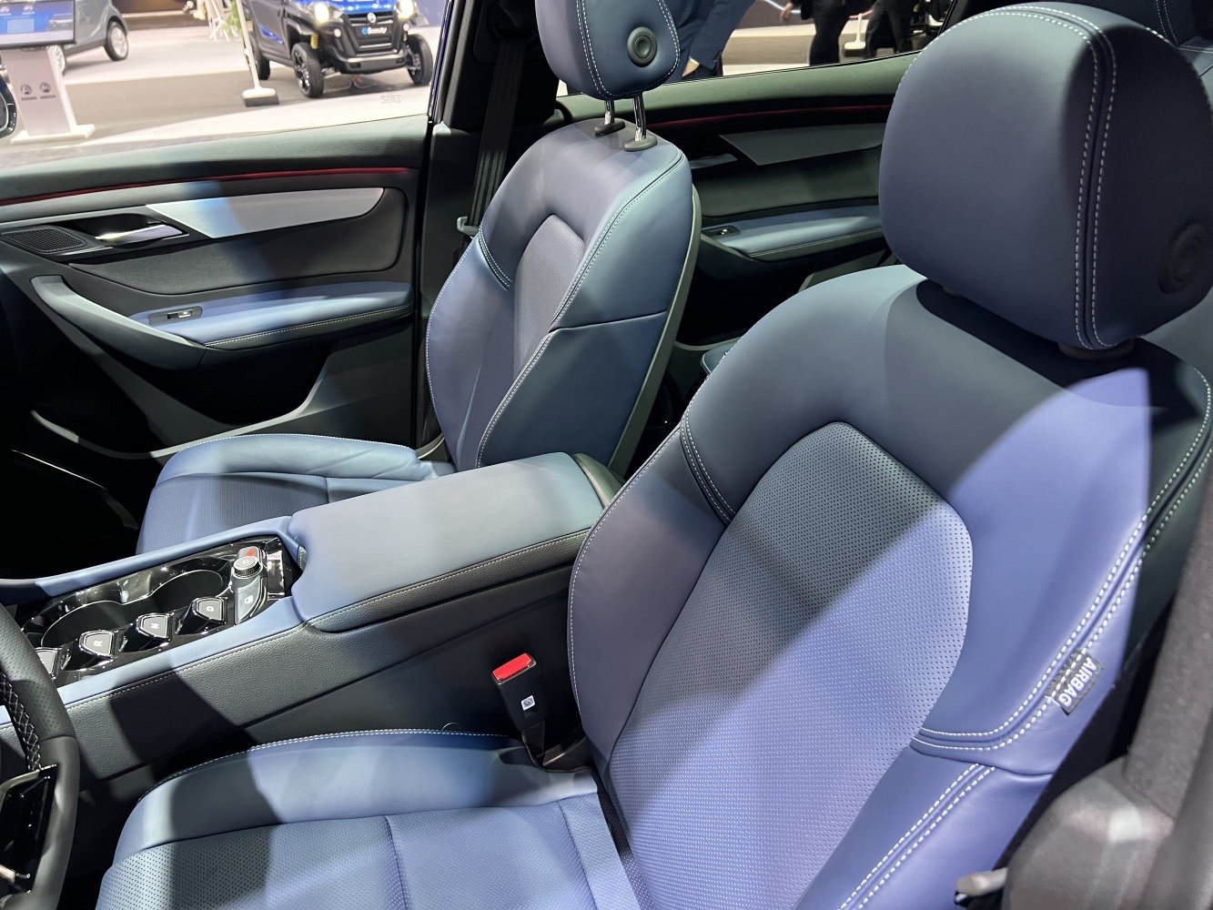 Blue leather front seats with detailed stitching and modern center console