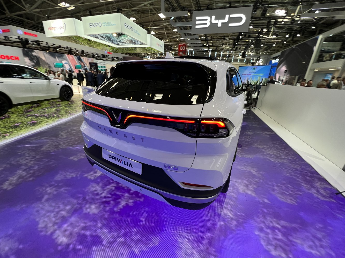Rear of an electric SUV with illuminated continuous LED tail light strip and bold rear styling