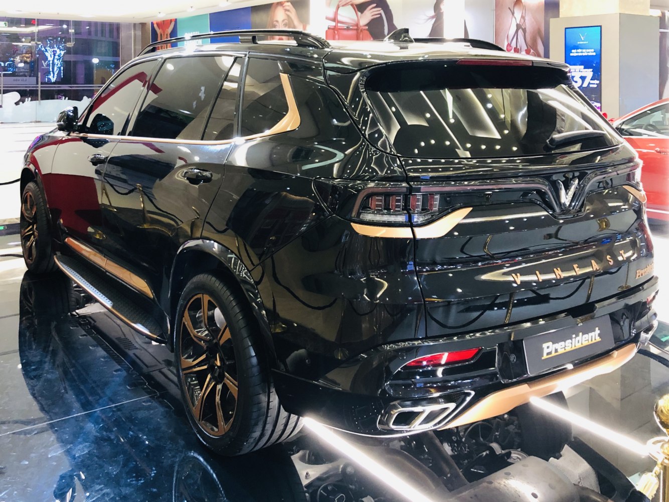 Black luxury SUV rear with alloy wheels and dual exhaust