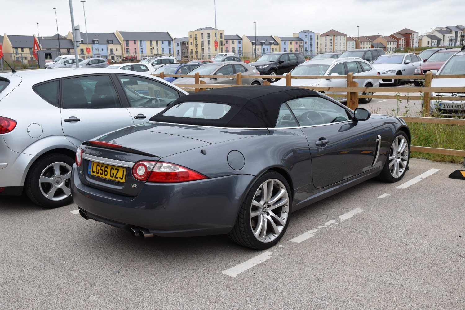 Convertible with black soft top, dual exhaust, and sporty rear details
