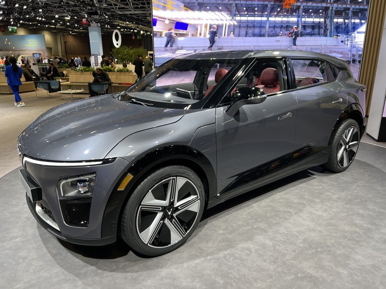 Front side view of gray modern electric SUV with LED headlights and stylish alloy wheels