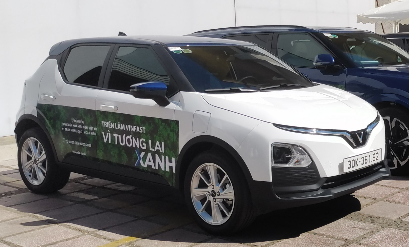 Front and side view of compact SUV with distinctive headlights and promotional side decals