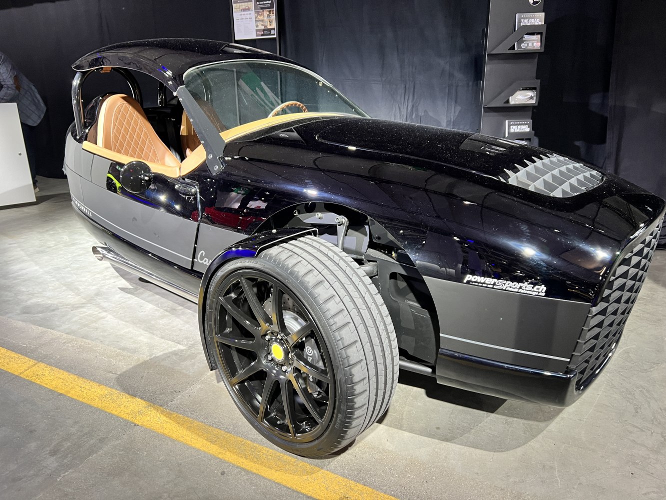 Exposed front suspension and sleek body of a unique three-wheeled sports vehicle