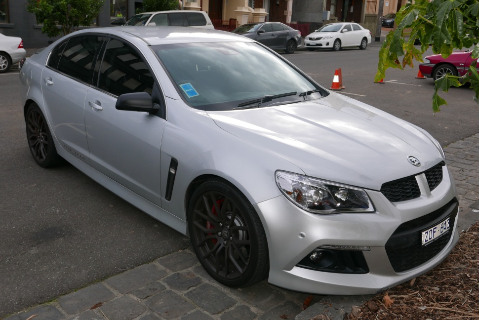 Silver sedan with black rims and aggressive front grille
