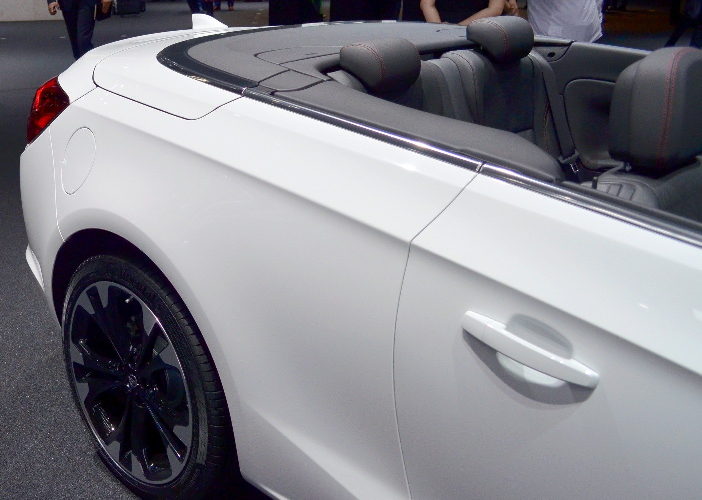 Rear side view of convertible with black alloy wheels and open interior
