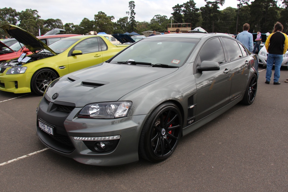 Grey performance sedan with hood scoops and black multi-spoke wheels