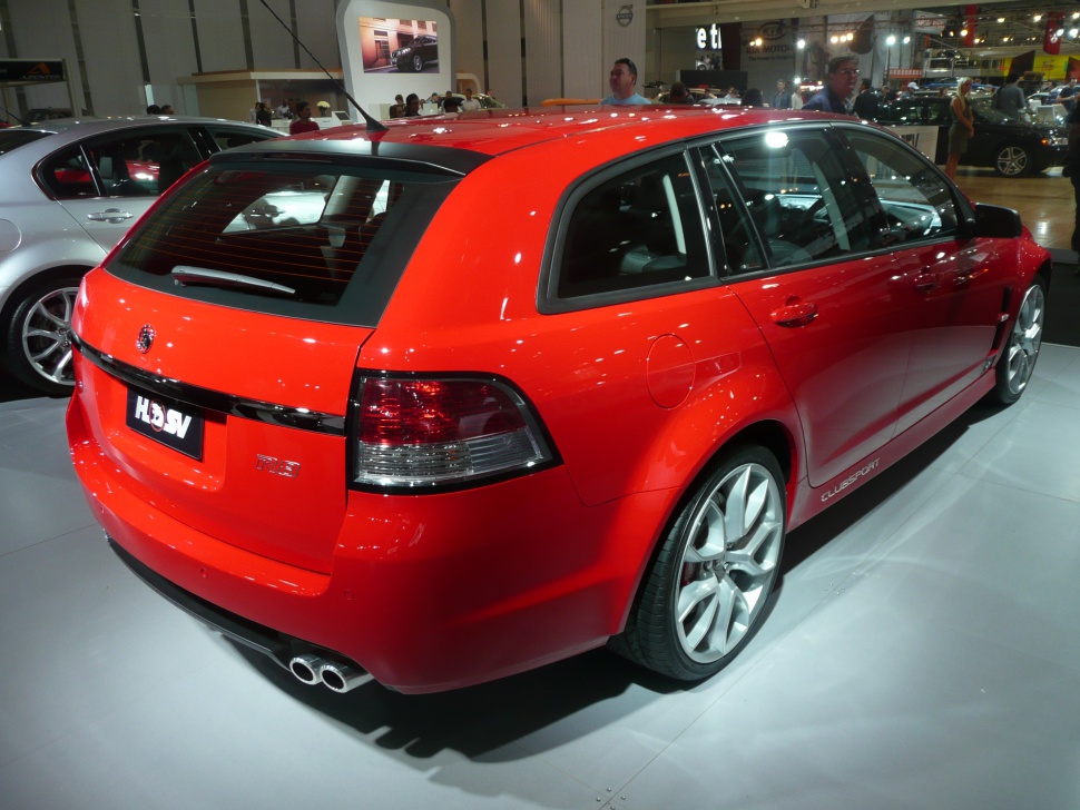 Red sporty wagon rear-side angle with dual exhausts and tinted rear lights