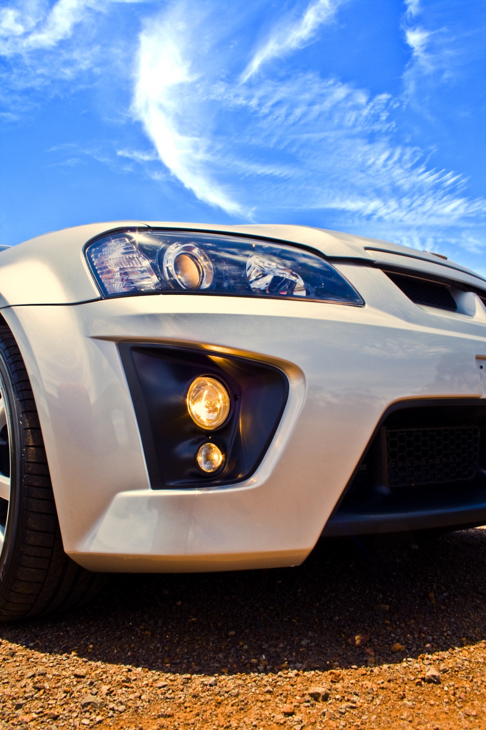 Close-up on front headlight and fog lights with aggressive styling