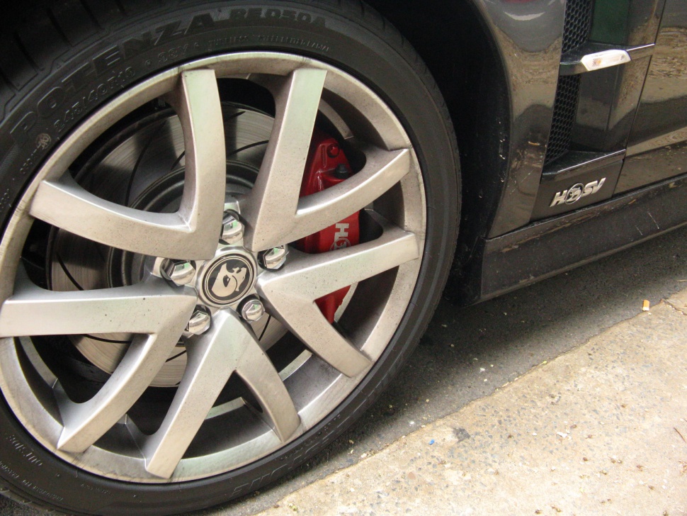 Close-up of alloy wheel with red brake caliper and tire