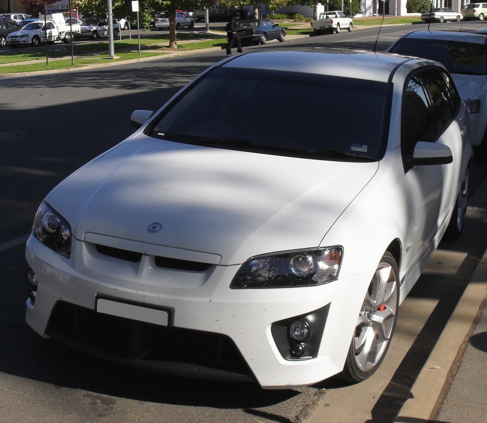 White sedan with aggressive front fascia and sporty wheels