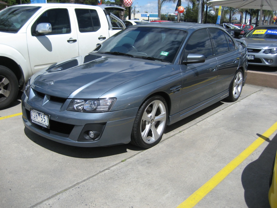 Front-side view of sedan with alloy wheels and aggressive grille