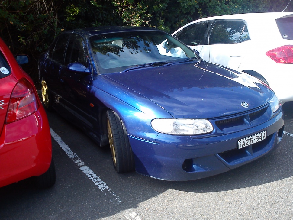 Blue HSV Clubsport VT sedan with gold wheels and sports styling
