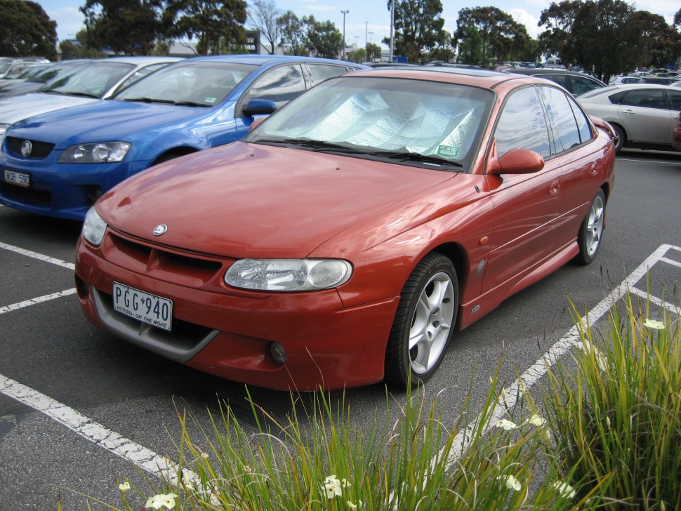 Red HSV Clubsport VT sedan with alloy wheels and distinct front headlights