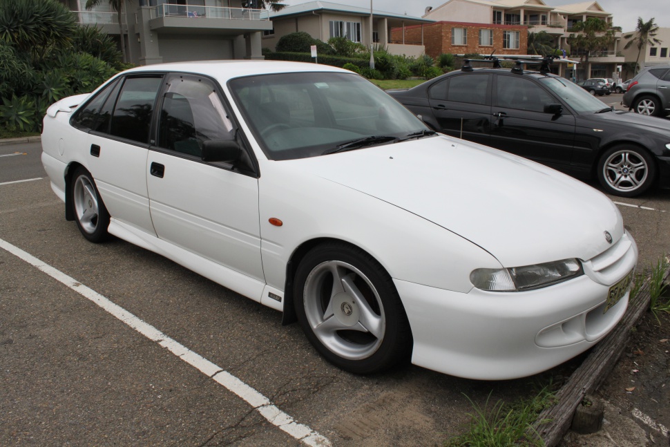 White sedan with aerodynamic body kit and racing alloy wheels