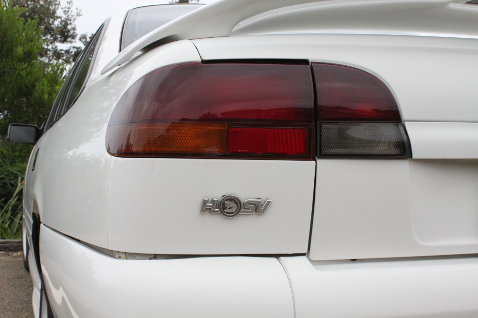 Close-up of rear tail light and HSV badge on white car