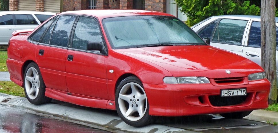 Red sedan with sporty body kit and alloy wheels