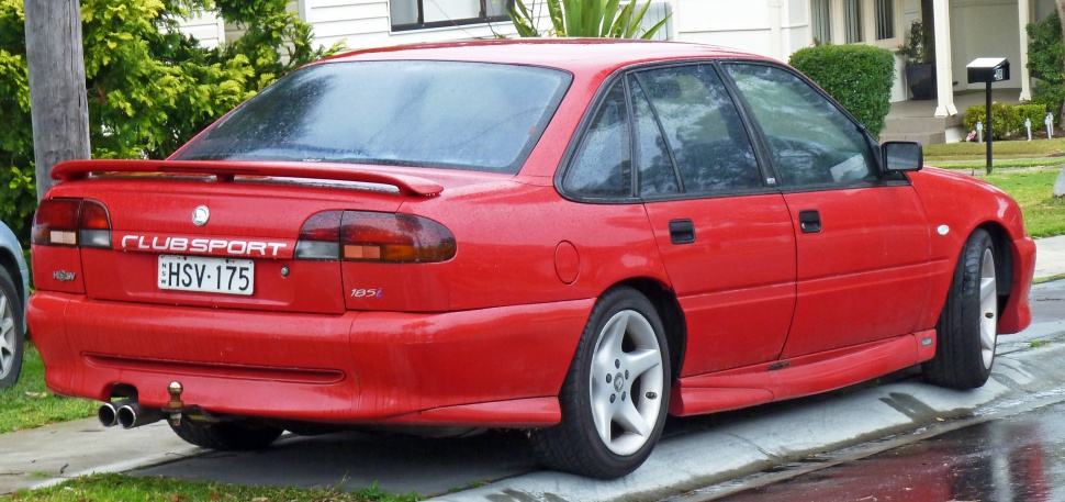 Rear view of sporty sedan with spoiler and dual exhaust