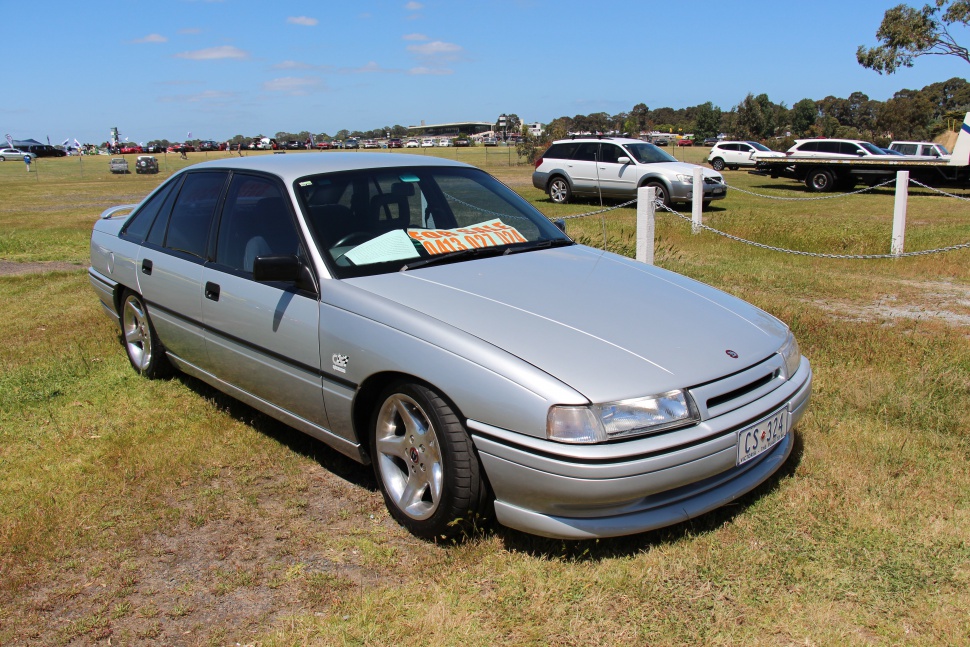 Silver four-door sedan with sporty front and alloy wheels