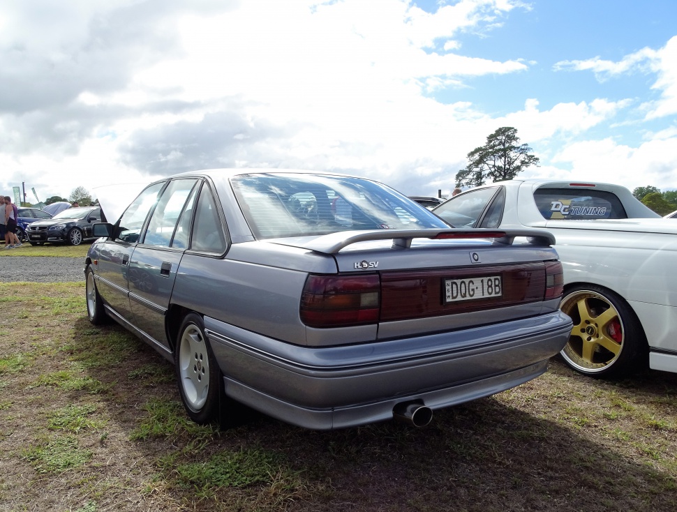 Rear view with spoiler, tail light cluster, and dual exhaust