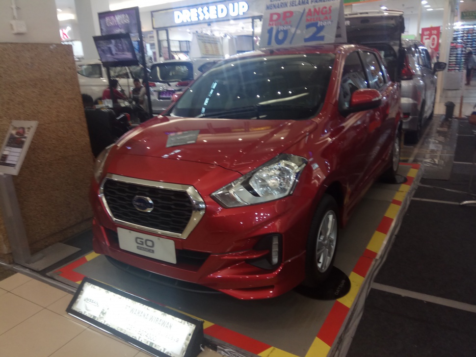 Red hatchback front with chrome hexagonal grille and angular headlights