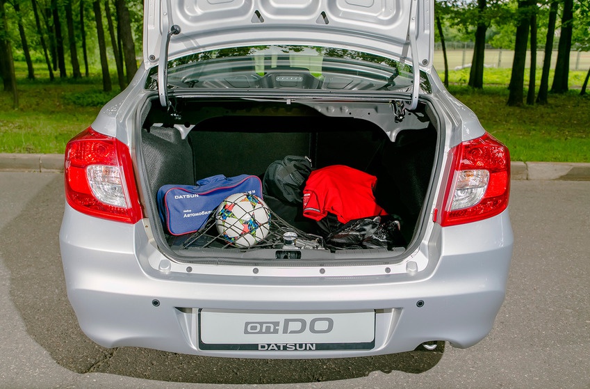 Open trunk loaded with sports and travel gear in a sedan