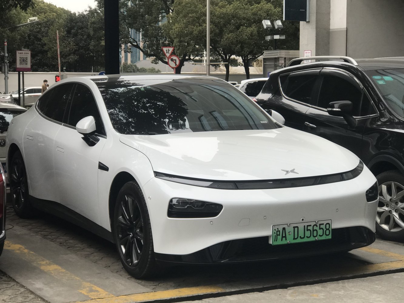 Sleek electric sedan with slim LED headlights and aerodynamic body.