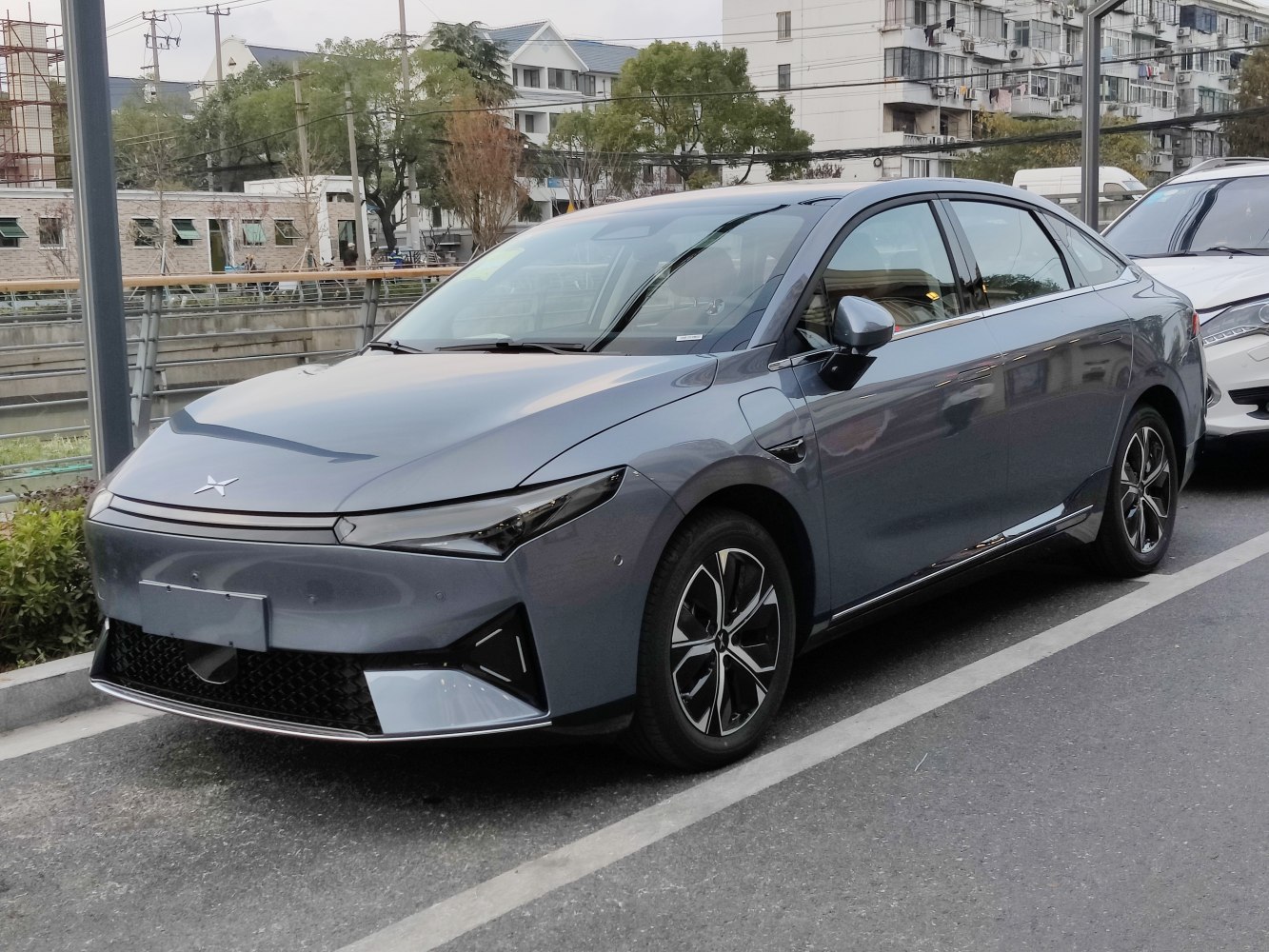 Sharp LED headlights and aerodynamic sleek electric sedan with alloy wheels