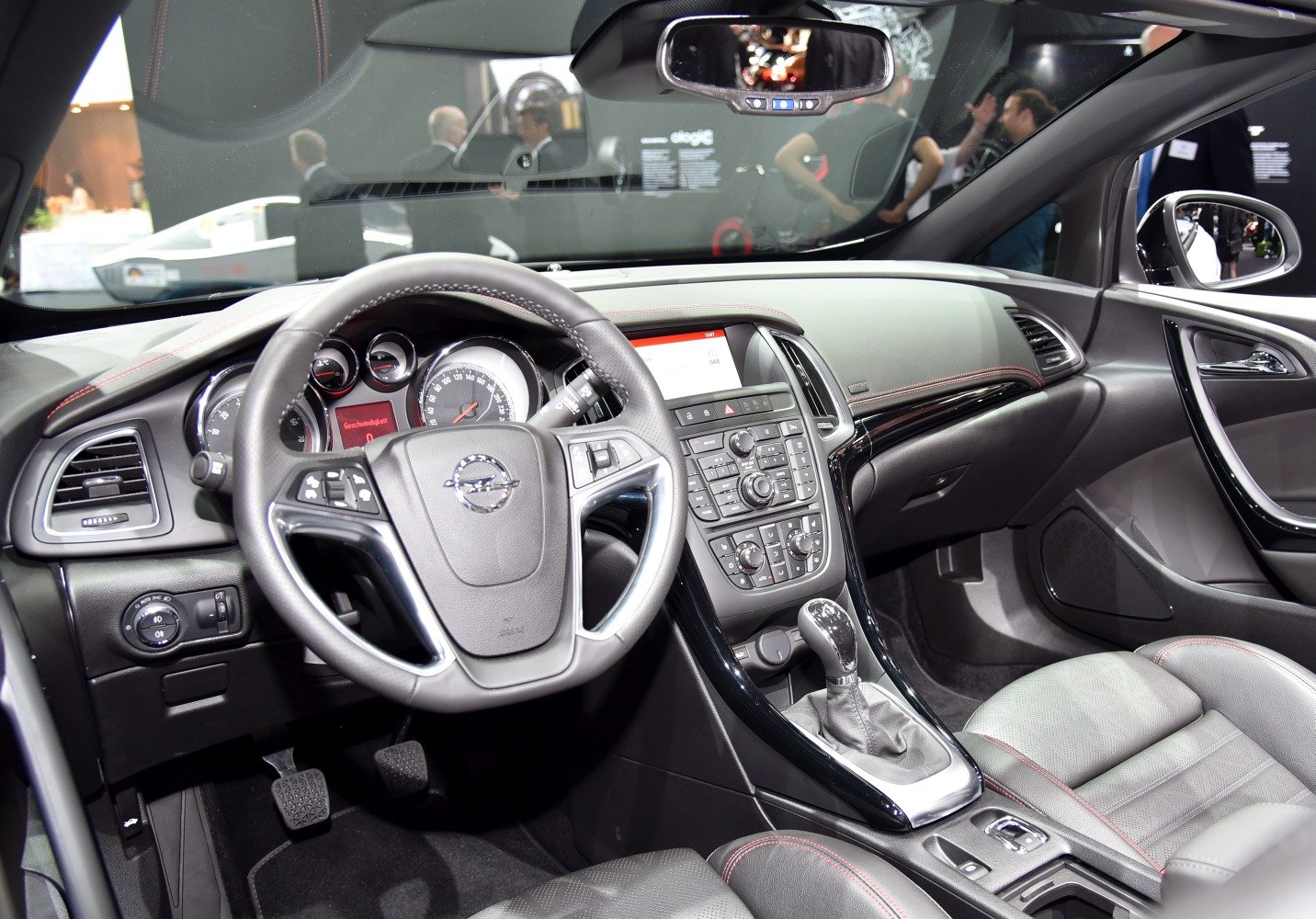 Modern car interior with steering wheel, gear stick, and dashboard controls